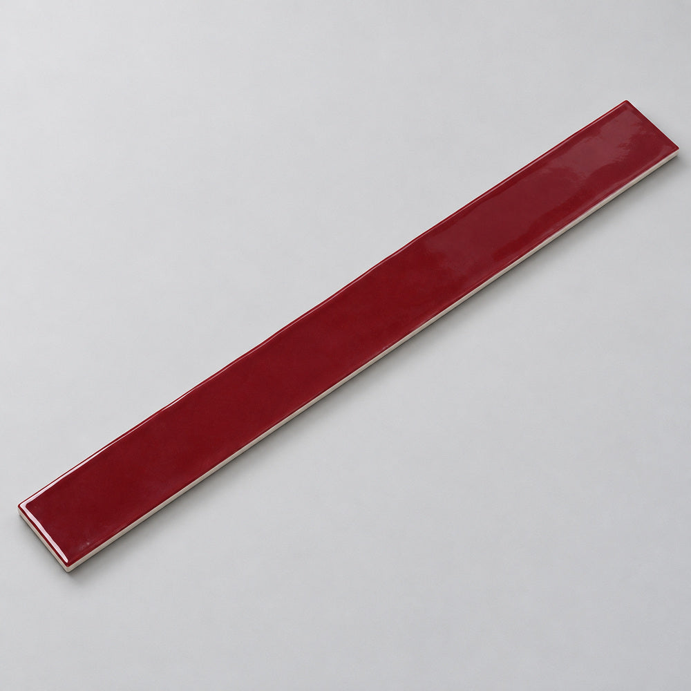 Ambrya ruby 2x20 glossy ceramic tile — angled full tile view