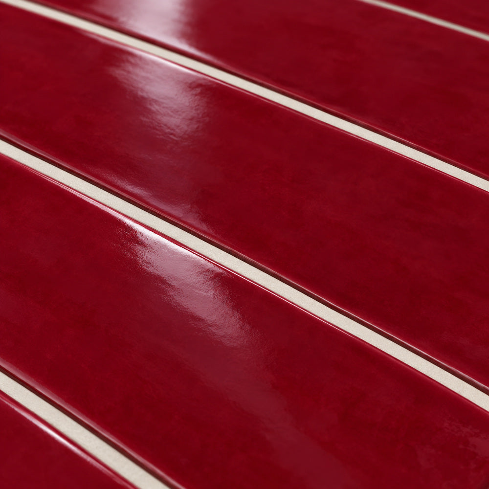 Ambrya ruby 2x20 glossy ceramic tile — angled glaze detail
