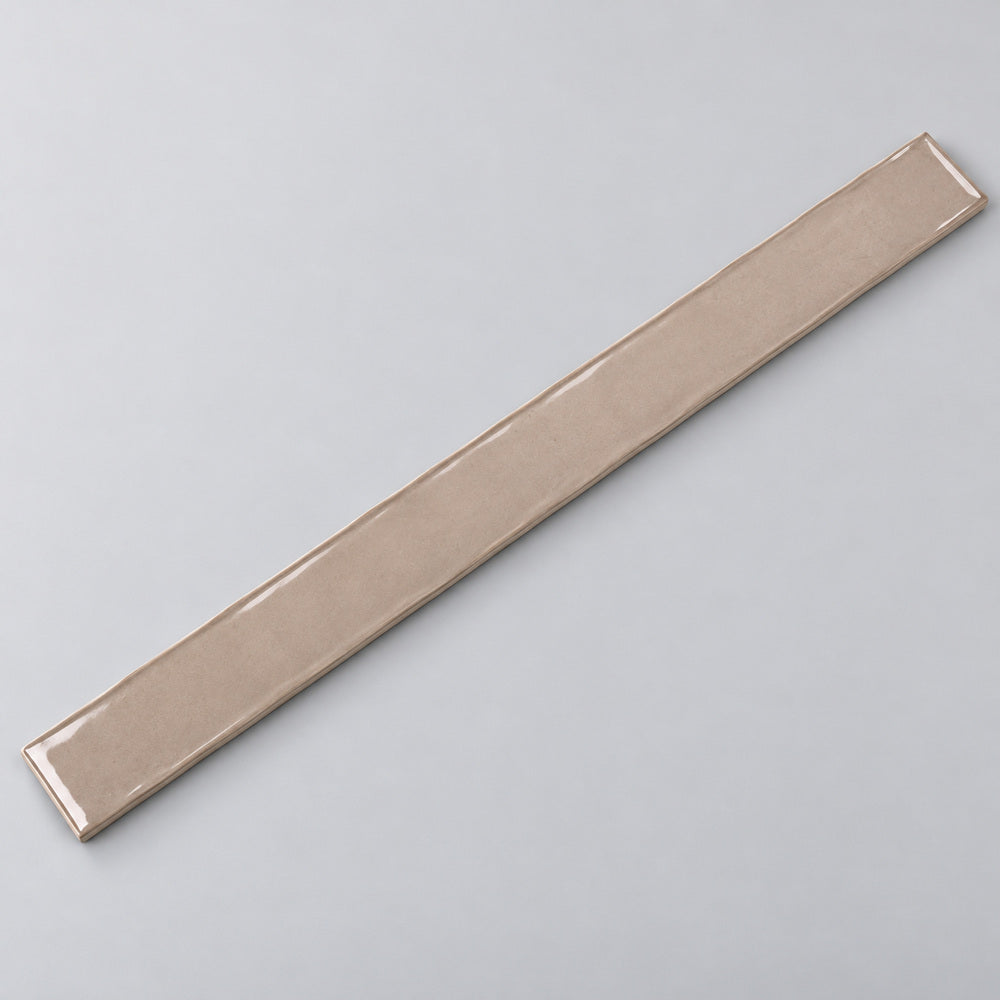 Ambrya sandstone 2x20 glossy ceramic tile — angled full tile view