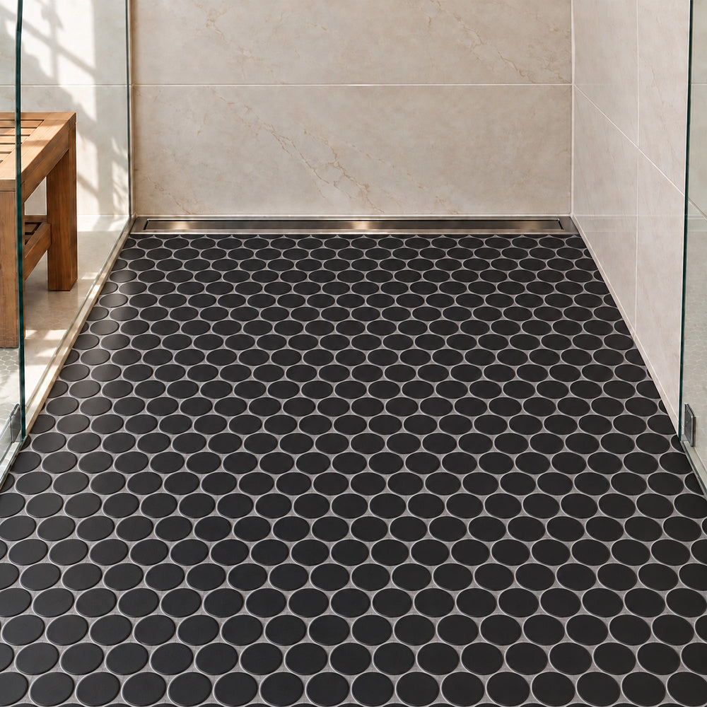 Simple Black Large Penny Round Ceramic Mosaic Matte installed on shower floor with aligned mosaic sheets