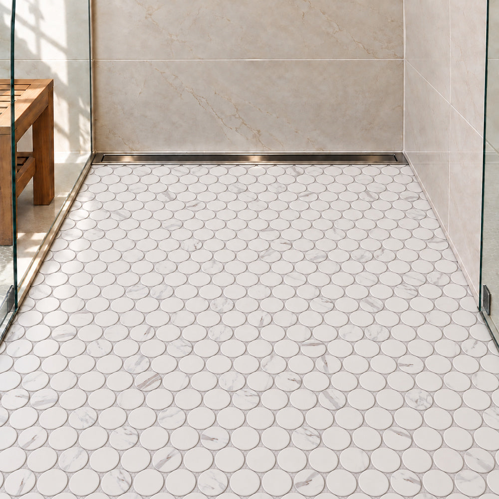Simple Carrara Blanco Large Penny Round Ceramic Mosaic Matte installed on shower floor with aligned mosaic sheets