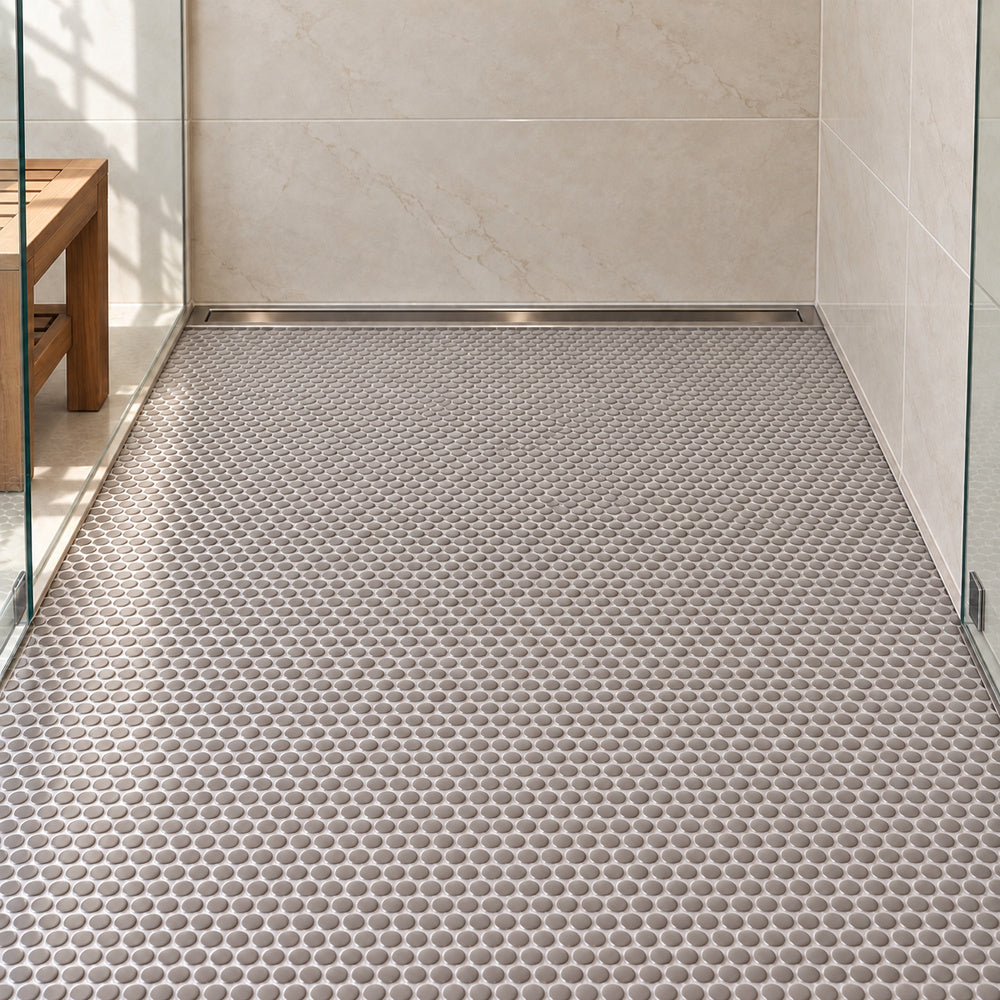 Simple Gray Penny Round Ceramic Mosaic installed with straight aligned penny-round mosaic sheets on shower floor