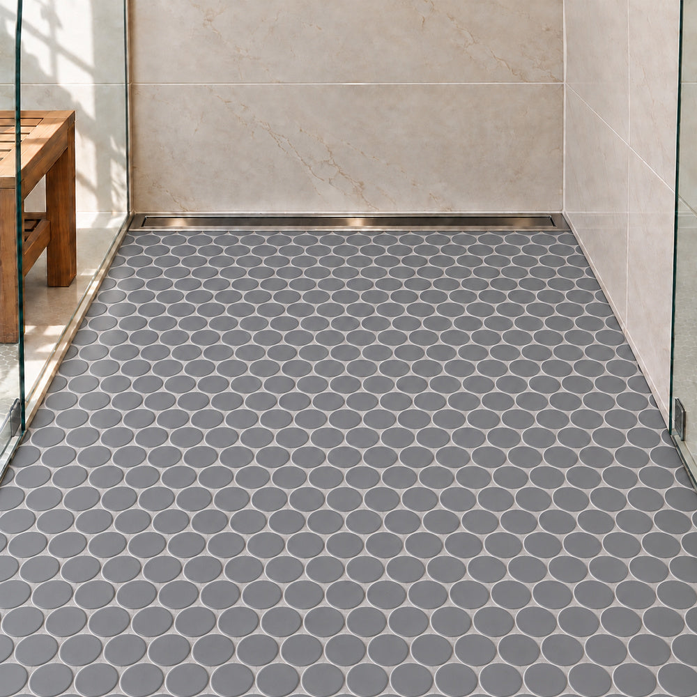 Simple Soft Gray Large Penny Round Ceramic Mosaic Matte installed on shower floor with aligned mosaic sheets